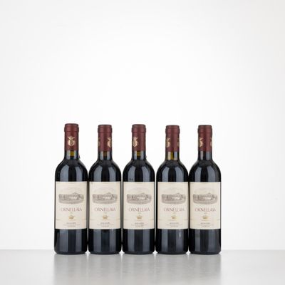 three bottles of red wine are lined up on a table