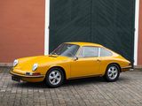 a yellow car that is parked in front of a building