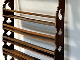 a wooden rack that has a bunch of shelves on it