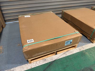 two boxes of cardboard sitting on a pallet in a warehouse