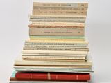 many books stacked on top of each other on a table