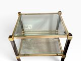 a glass and brass coffee table with two shelves