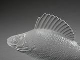 a glass fish that is sitting on a table