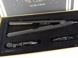 a black and gold gift box with a black and gold hair straightener and a black and gold hair clip