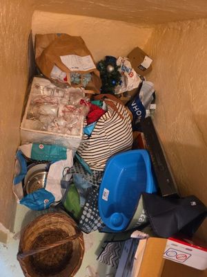 a pile of trash in the corner of a room