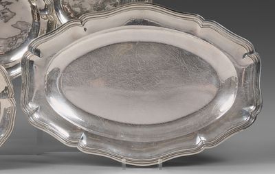 several silver plates with designs on them are stacked on top of each other