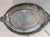 a silver plate with a gold rim on a white table
