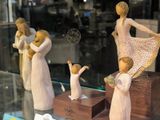 three figurines of people in a display case