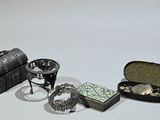 two rings and a purse sitting on a white surface