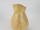 a small wooden vase that is on a white surface