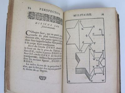 an open book with a drawing of a star on it
