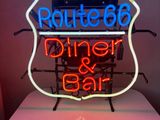 neon sign of route 66 diner and bar on a table