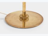 brass table lamp with a metal base and a gold plate with a flower design