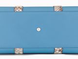 a close up of a blue purse on a white background