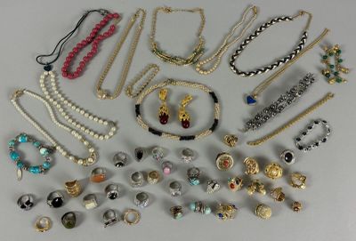 many different types of necklaces and bracelets laid out on a table
