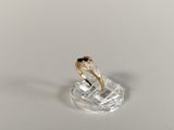 a gold ring with a black stone on top of it