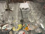 many glasses and plates on a glass table