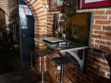two stools in front of a table with a laptop on it