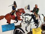 many figurines of men riding horses on display