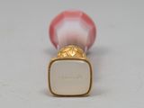 a close up of a pink and white object on a table