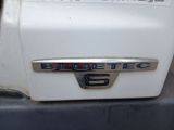 a close up of a blue tec emblem on a white truck