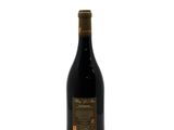 a bottle of wine sitting on top of a white surface