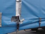 a blue truck with a tarp on the back of it