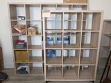 a room with a bookcase and a chair in it
