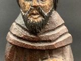wooden figurine of a man with a beard and a hat