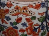 a vase with a flower design on it sitting on a table