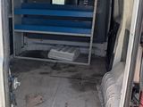 an image of a van with the door open and a bench in the back
