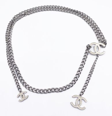 a close up of a chain with two charms attached to it