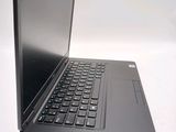 a laptop with a black keyboard sitting on a white surface