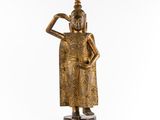 une statue en bronze représentant une personne portant un chapeau sur la tête