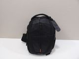 a black backpack sitting on top of a table next to a wall