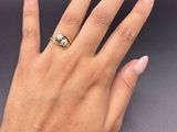 a woman ' s hand with a ring on her finger