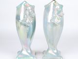 two vases that are sitting side by side on a white surface