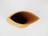 a yellow vase that is sitting on a white surface