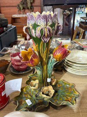 a vase with flowers on it sitting on a table
