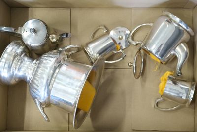 a box with a bunch of silver items inside of it