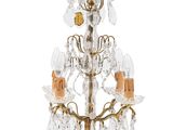 chandelier with five lights and a gold base with crystal drops