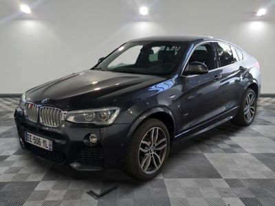 the bmw x4 is parked in a garage with a checkered floor