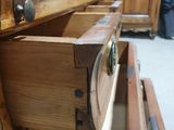 a wooden drawer with two open drawers in a room