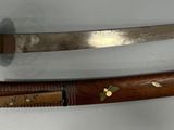 two different types of knives on a white surface