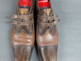 pair of men ' s brown leather shoes with buckles on them