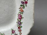 a white plate with flowers on it on a table