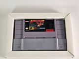 an old nintendo game is in a white box on a white surface