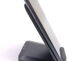 a cell phone on a stand on a white surface