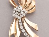 an image of a gold and diamond bow brooch