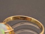 a ring with a white oplite in it sitting on a table